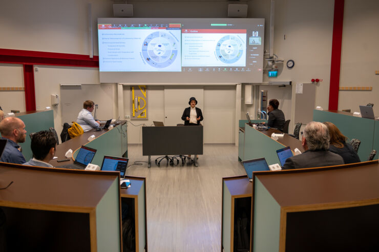 People in the lecture hall, listening to professor. 