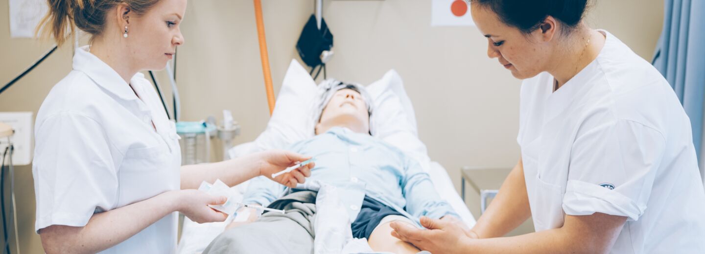 Two nursing students practice in Clinicum. 