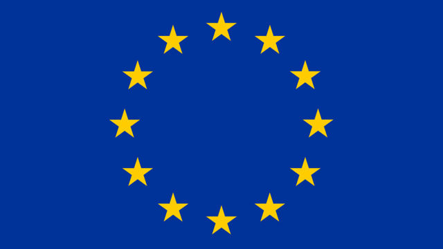 The EU flag, blue background with yellow stars.