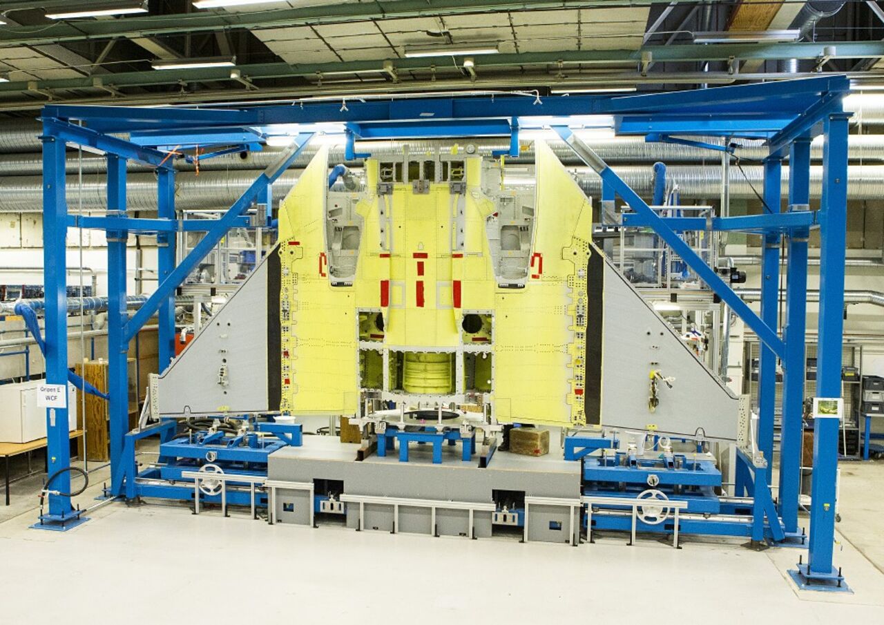 Men working on assembling an aircraft.