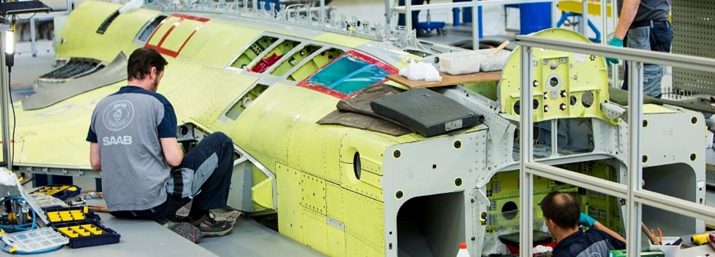 Men working on assembling an aircraft.