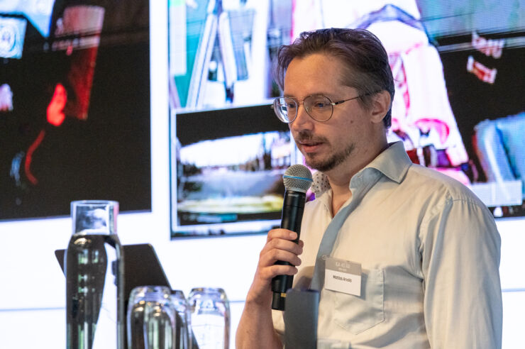 Male researcher lecturing.