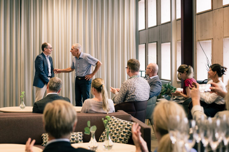 Two men in front of an audience