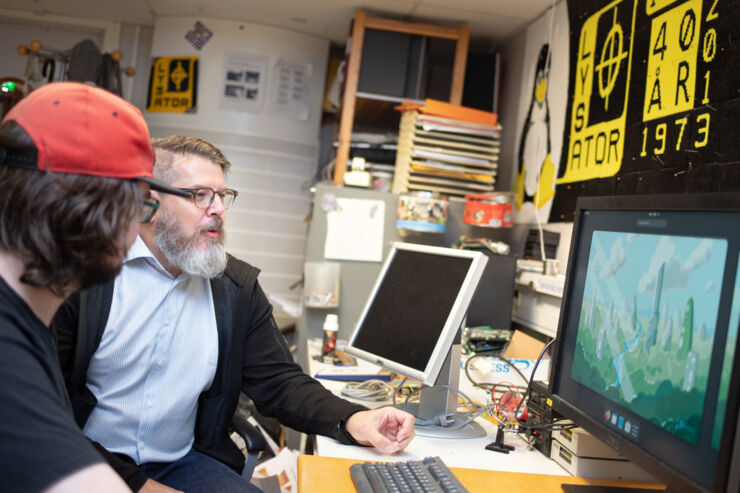 Leif Nixon is sitting in Lysator's room with a person with dark hair and a red cap.