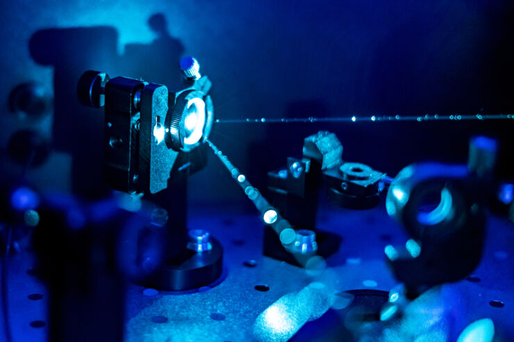 Blue laser in dark laboratory.