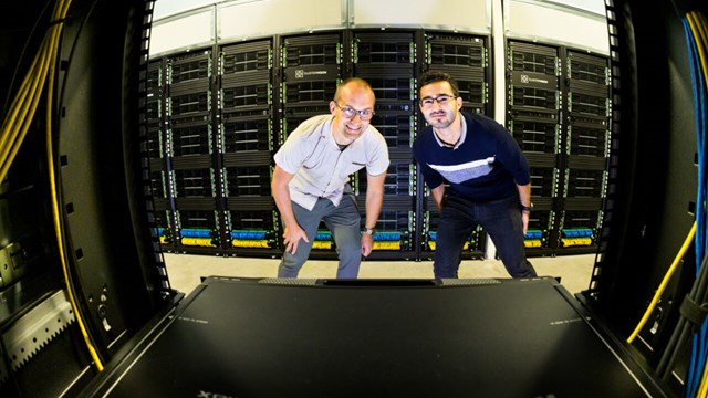 Mika Gustafsson and David Martinez peeking into a server rack in the data center in Kärnhuset, NSC.