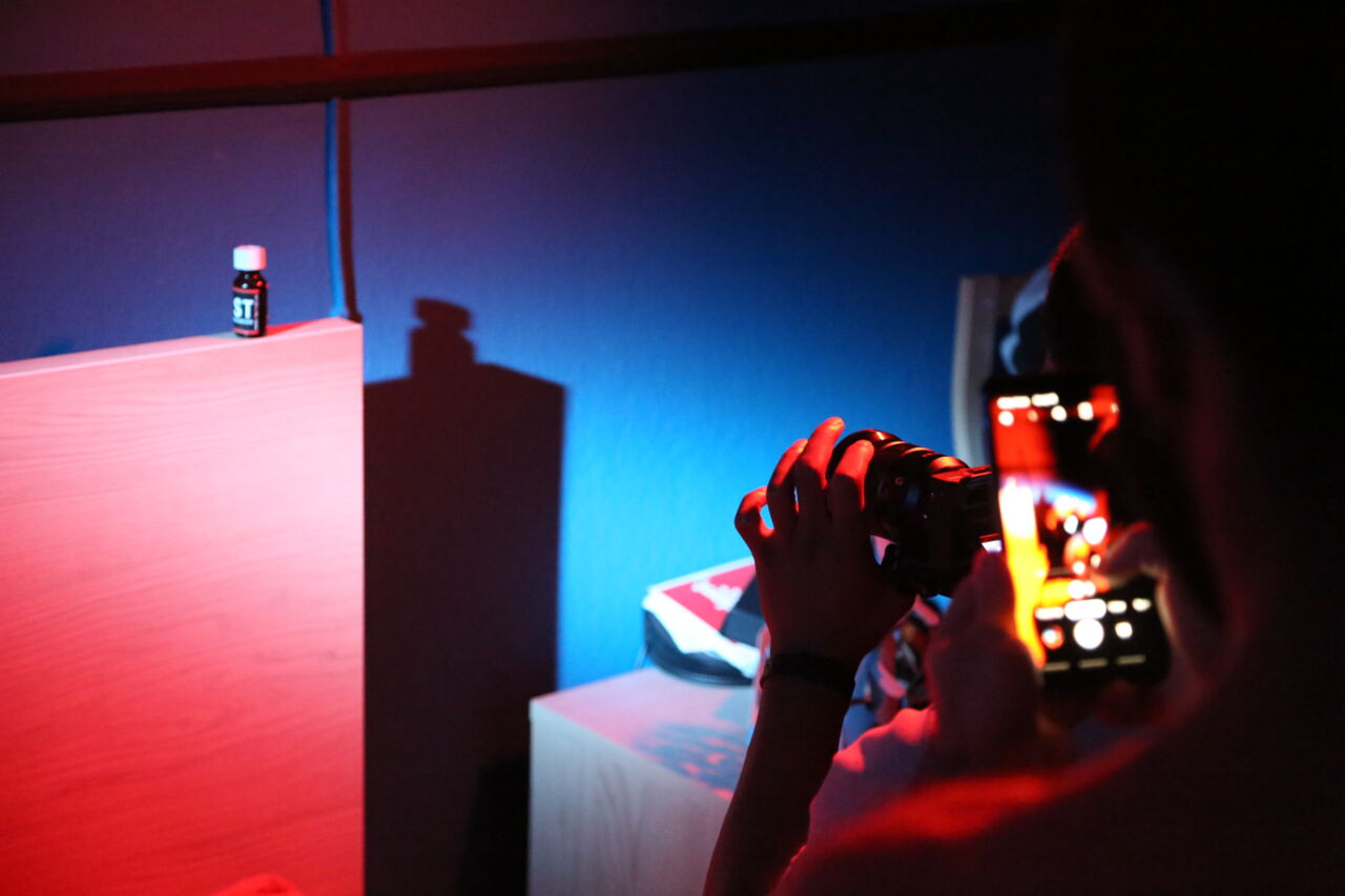 A video camera and a mobile is filming in a dark room