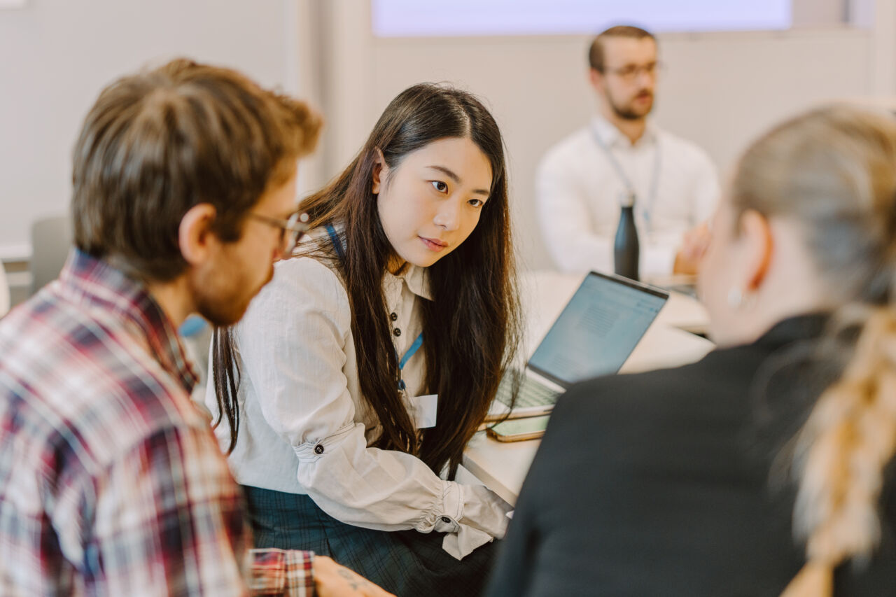 Three students in discussion during a role play session