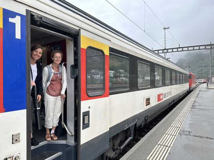 Two women in the doorway of a train.