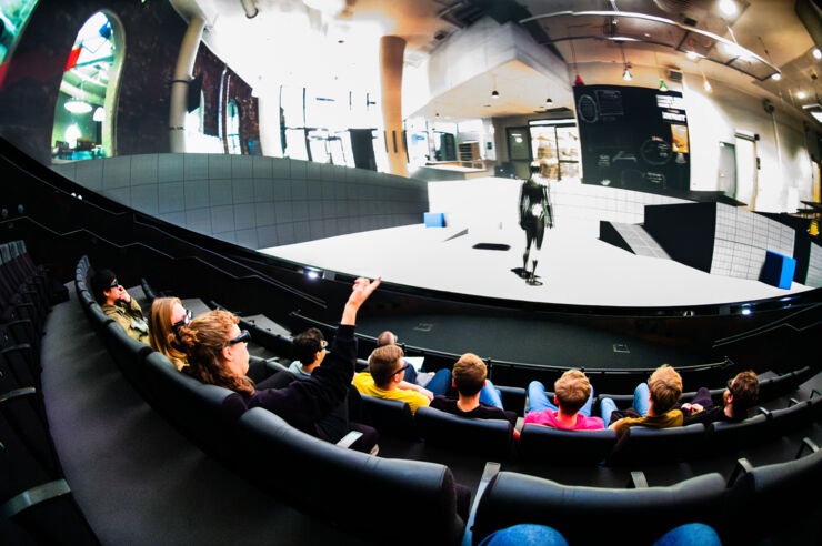 Young people in front of a dome theatre film