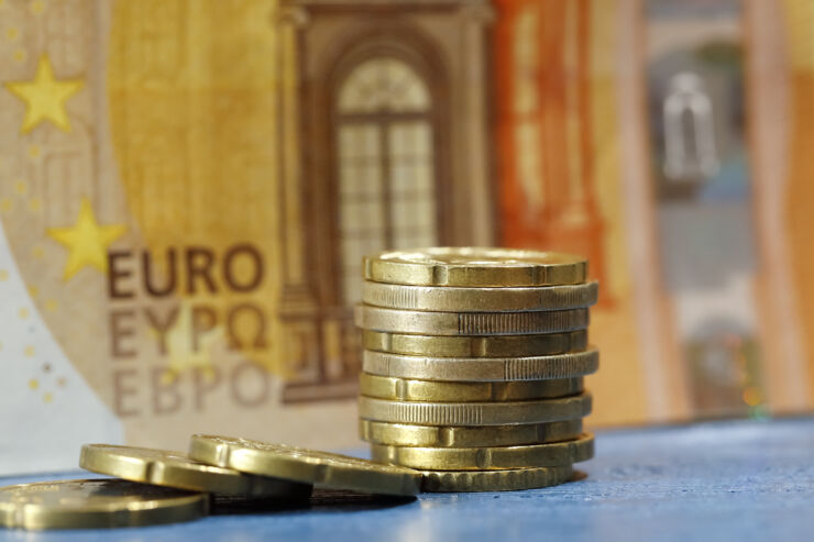 Euro coins stacked in pile.