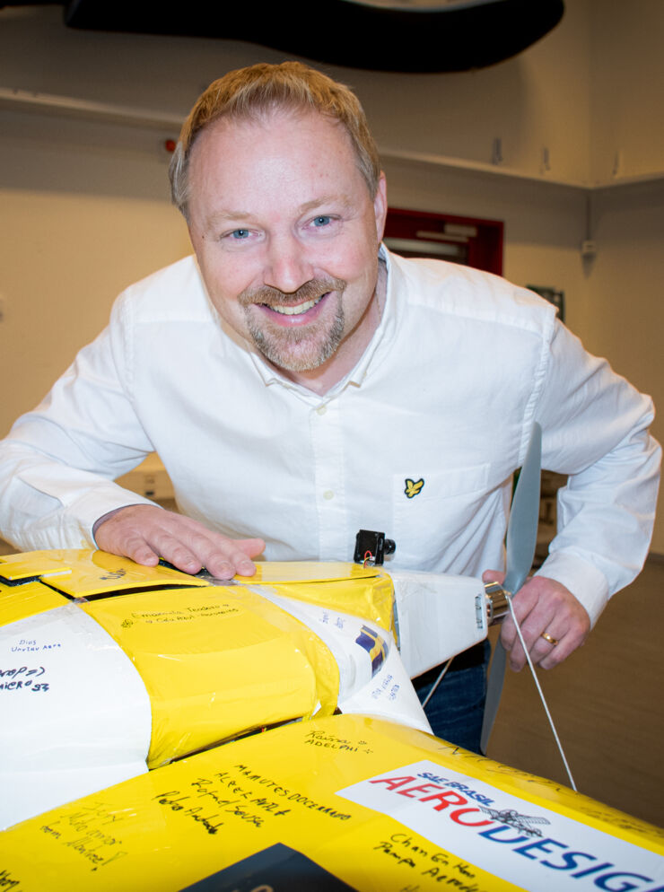 Scientist by a remote controlled airplane.