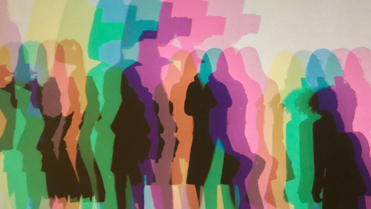 People in silhouette in different bright colours