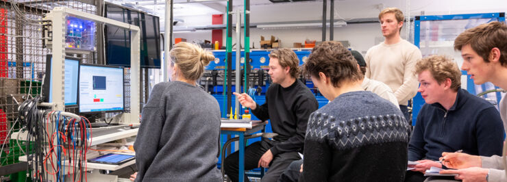 Group of students in lab looking at computer monitor