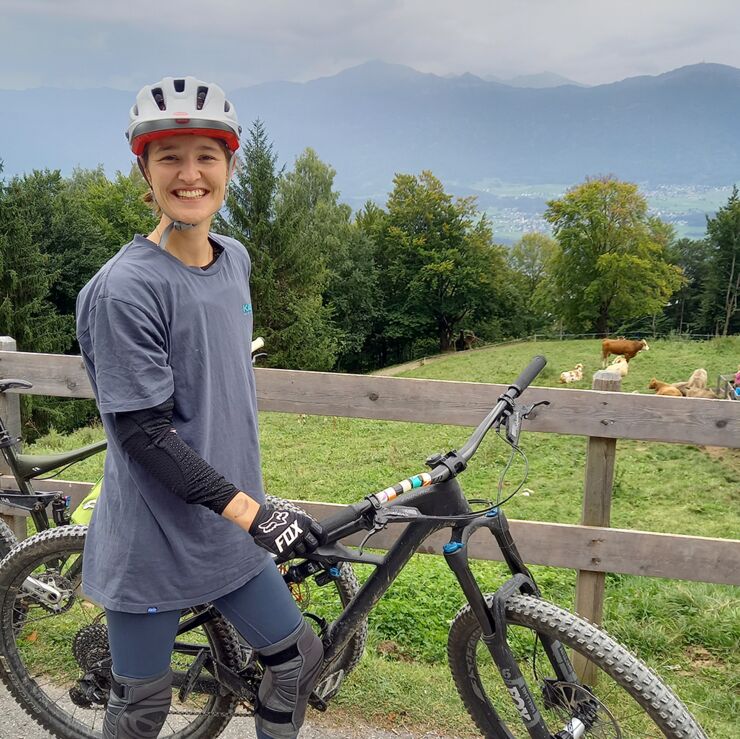 Woman on a bike out in nature.