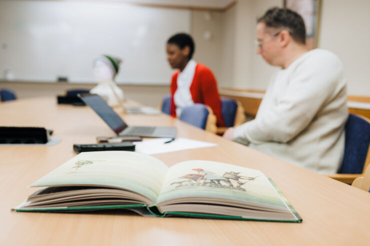 Two researchers and an open book.