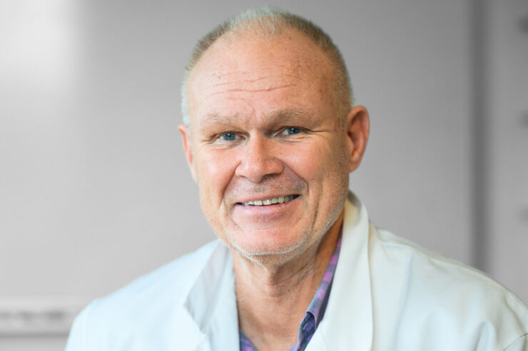 Headshot of man wearing lab coat.