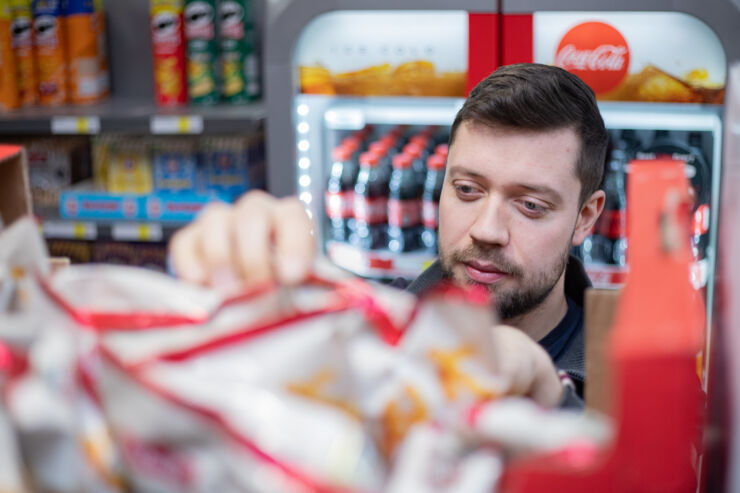 A man picks up goods in a grocery store