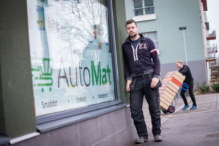 Man standing outside a food shop