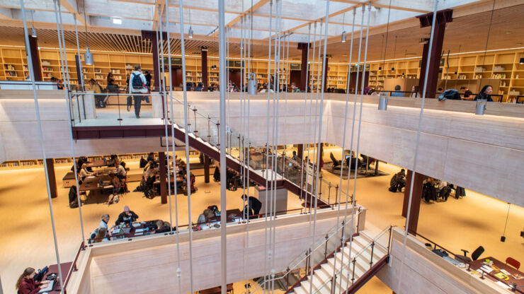 A wooden staircase in a large building.