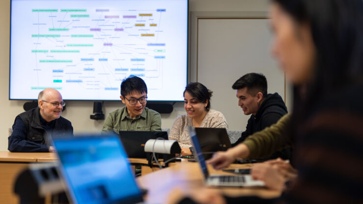 Teacher and students with laptops interact