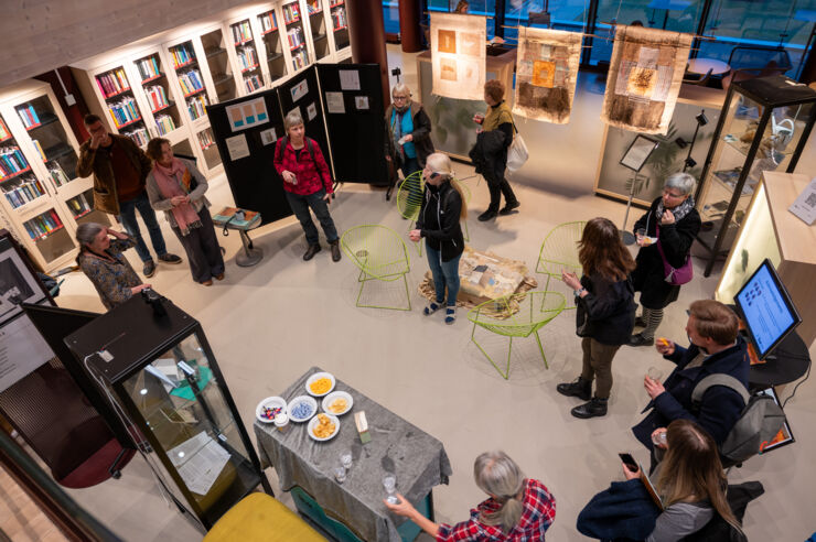 Art and Science exhibit opening with people who are mingling.