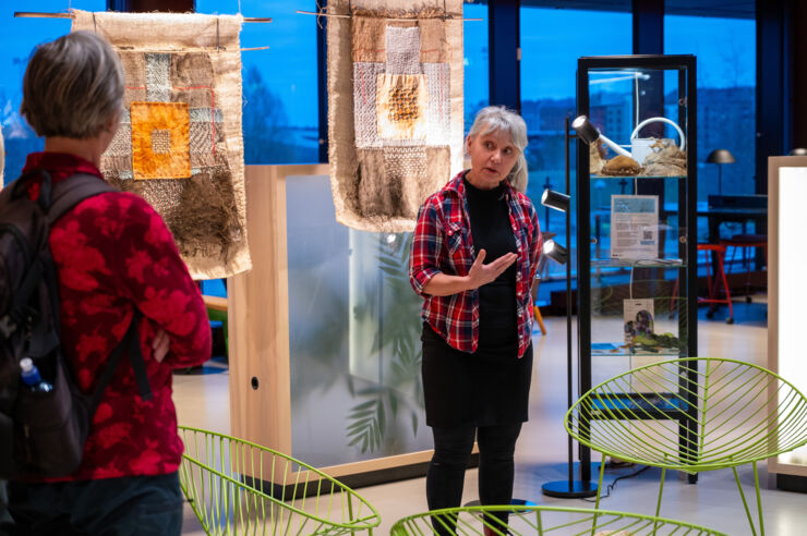 Art and Science exhibit opening with people who are mingling.