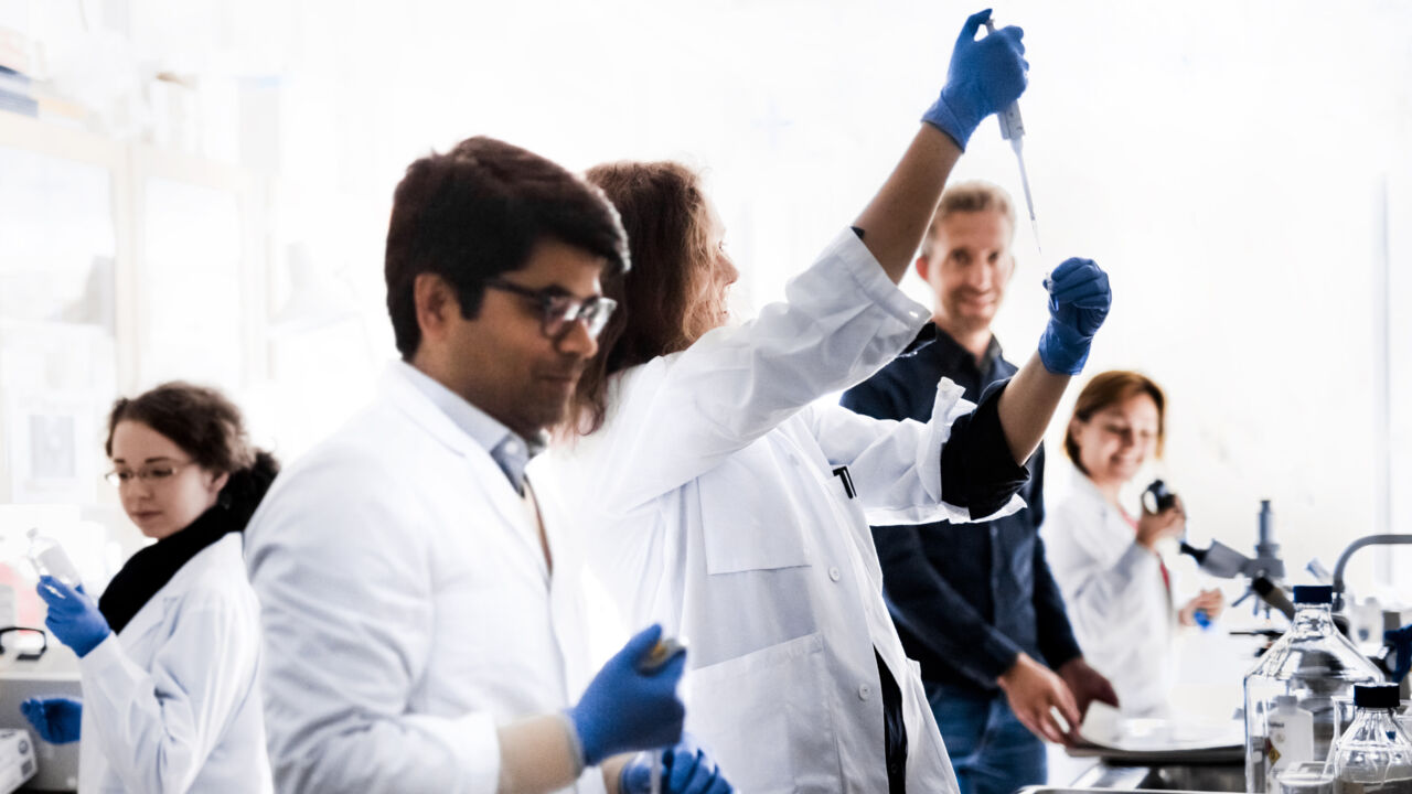 Five people in a laboratory.