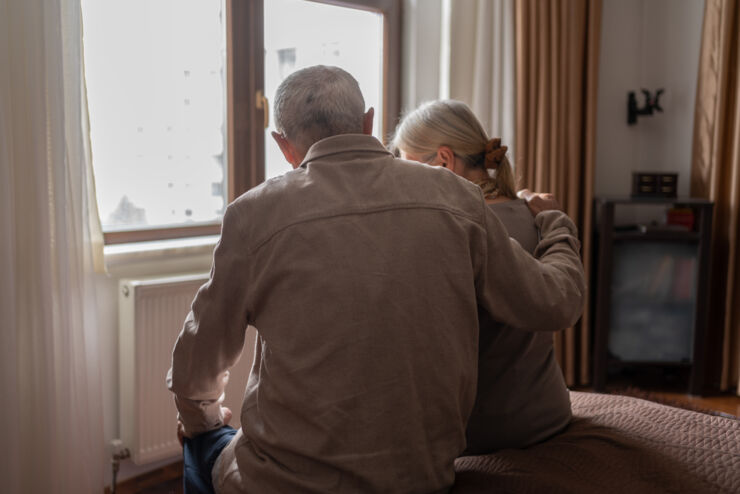 Old man and woman sitting facing away from the camera.