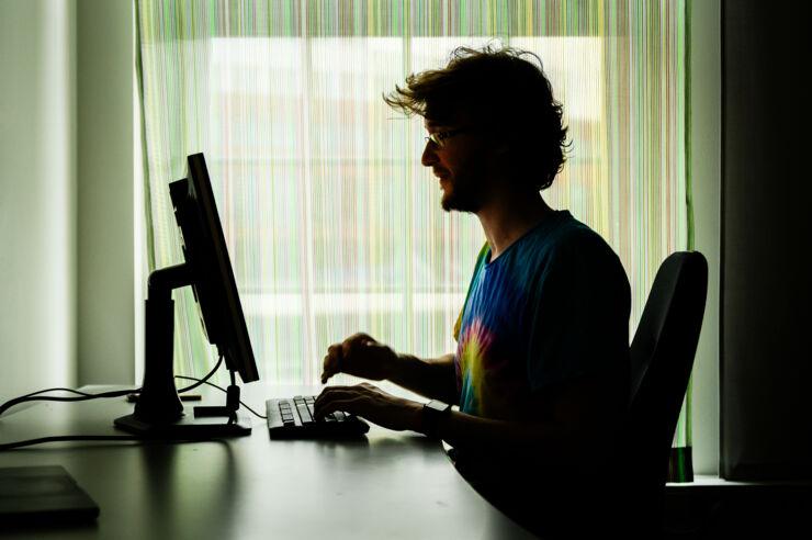 Person infront of computer with strong backlight.