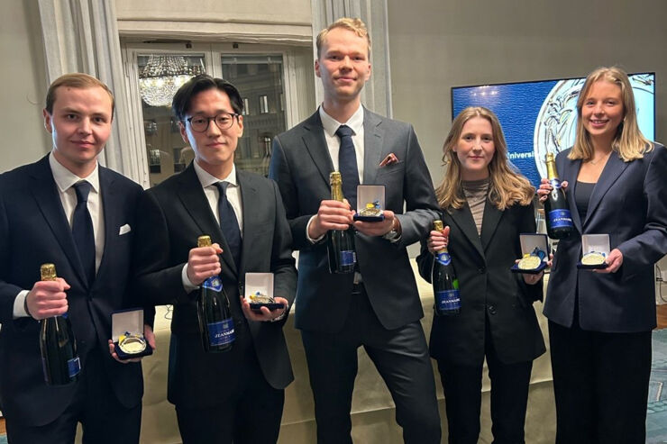 Five people each holding a medal