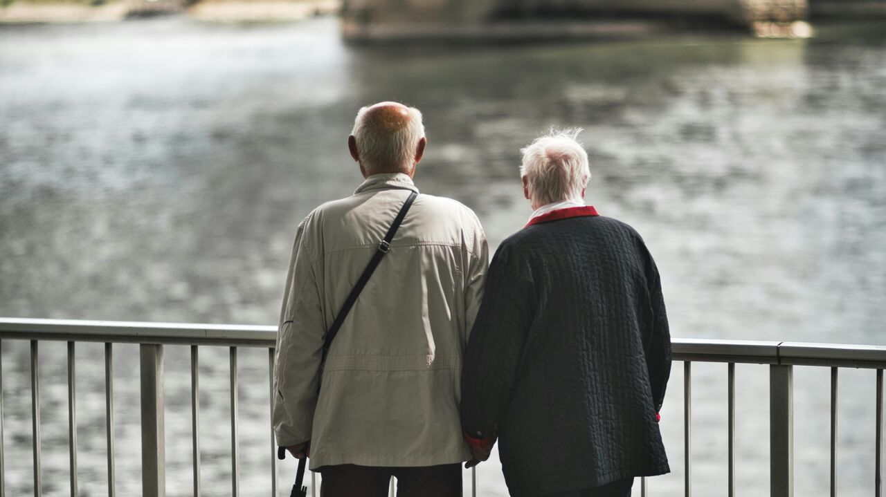 An eledery couple that are gazing out over the water.