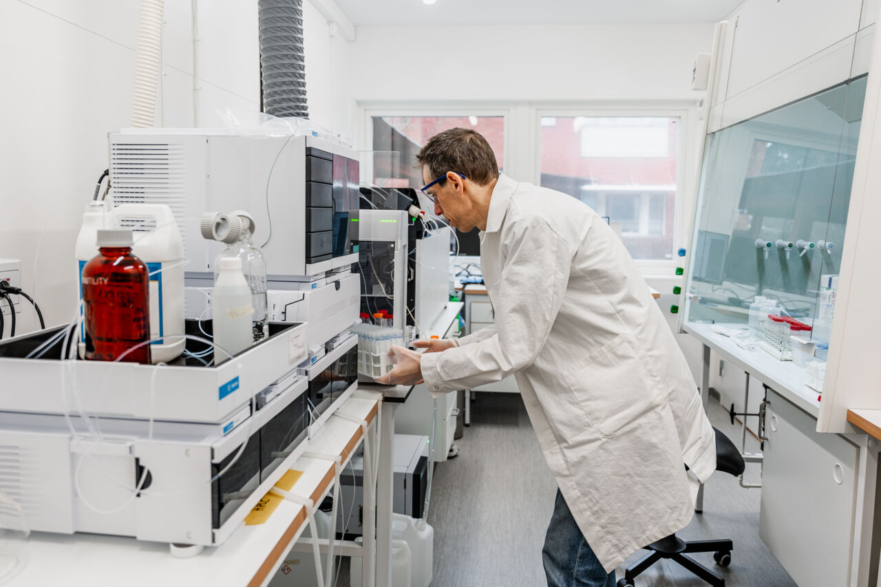 En forskare håller på med ett instrument i miljöforskningslaboratoriet