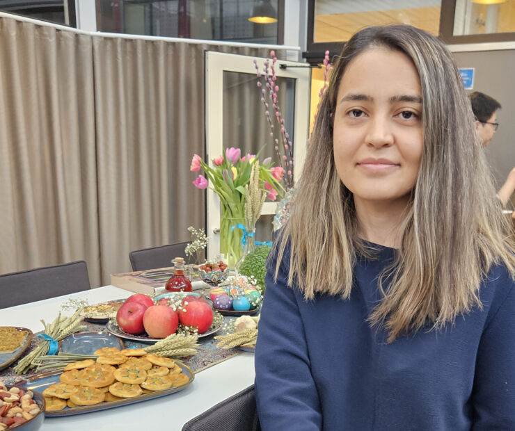 Mina Niknafs in front of the table with food 