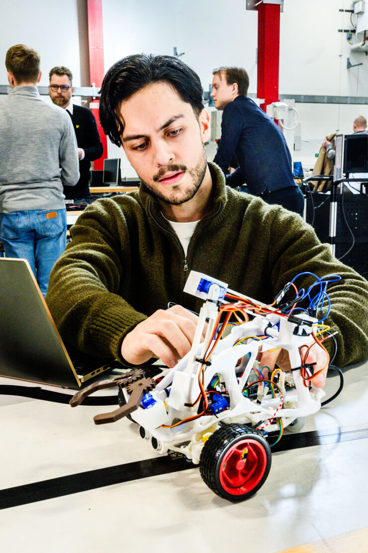 male student with robot.