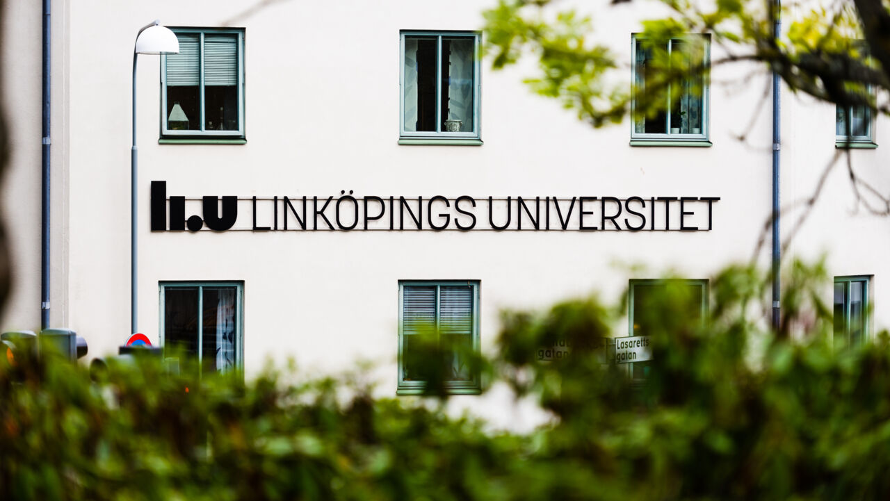 A white facade with Linköping University's logotype in black.