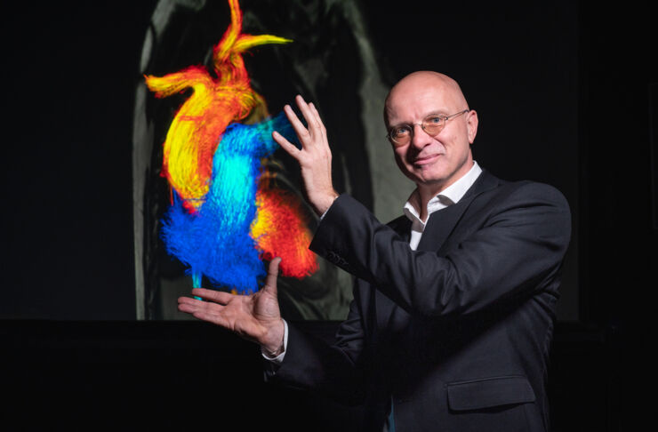 Man framing an illustration of a heart with his hands.