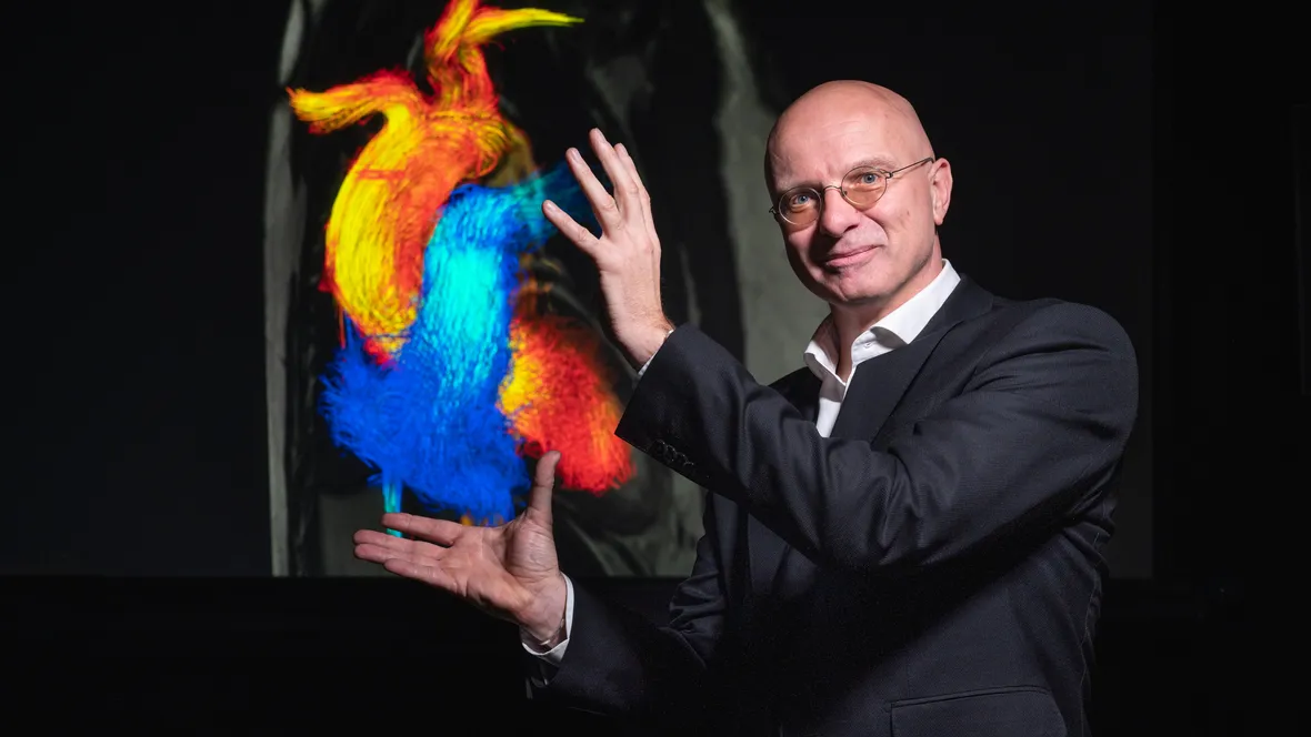 En man som håller händerna runt en illustration av ett hjärta.