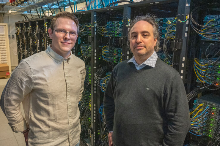 Two men in a computer server hall.