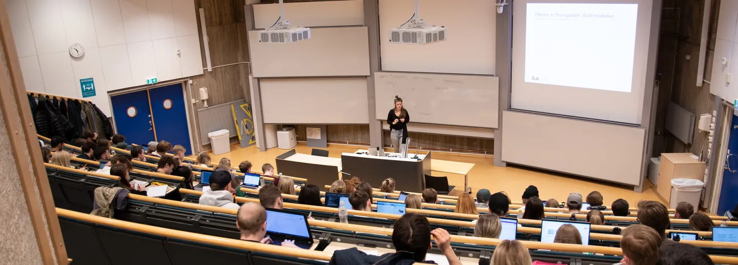 A lecture room with students and teacher