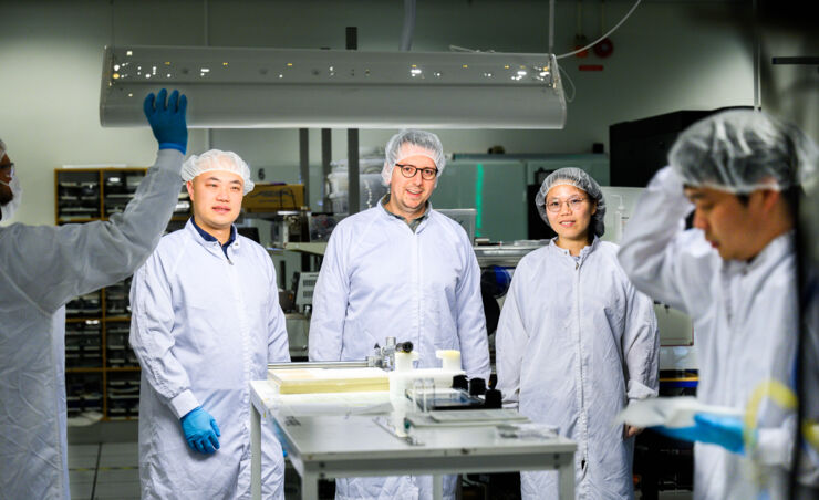 Three researchers in white lab coats.