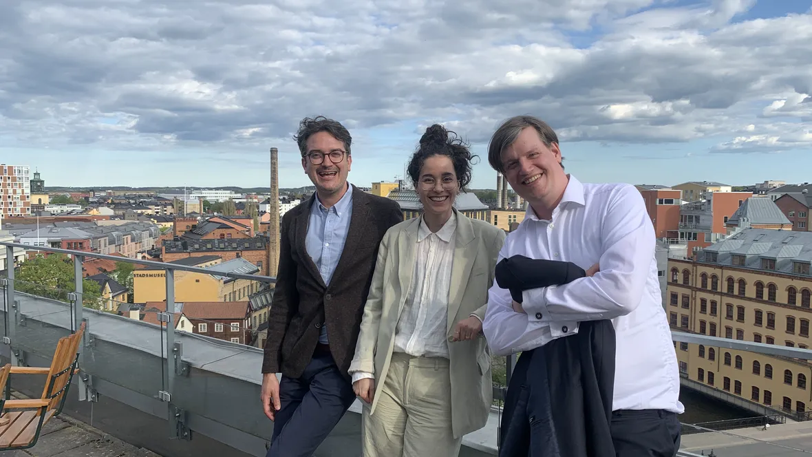 Three glad persons celebrating. 