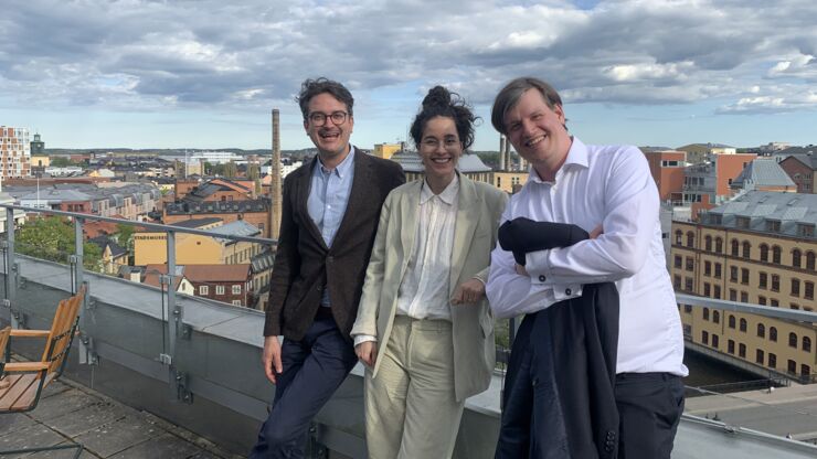 Three glad persons celebrating. 