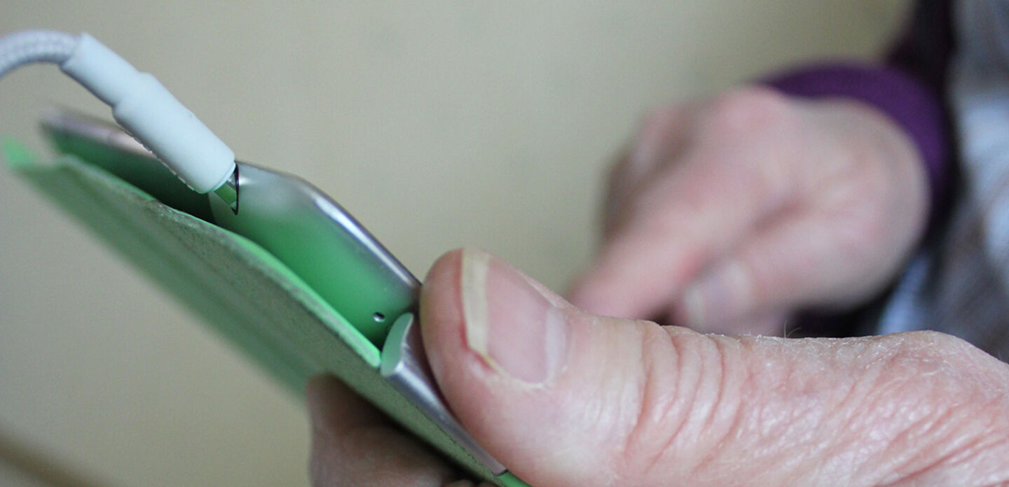 Elderly hands holding cell phone