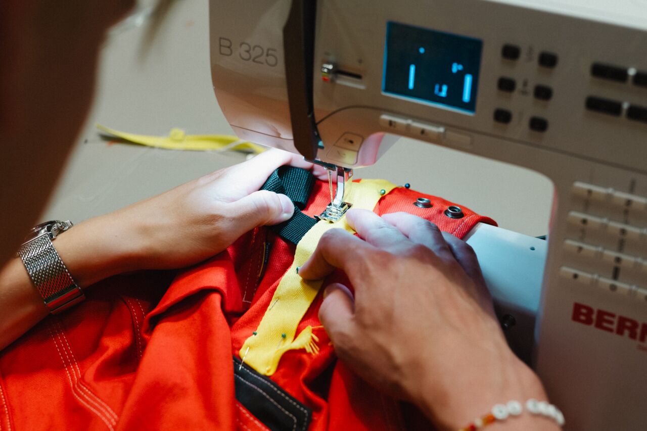 A person using a sewing machine.