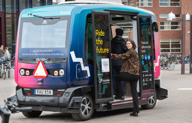 Woman boarding an autonomous vehicle.