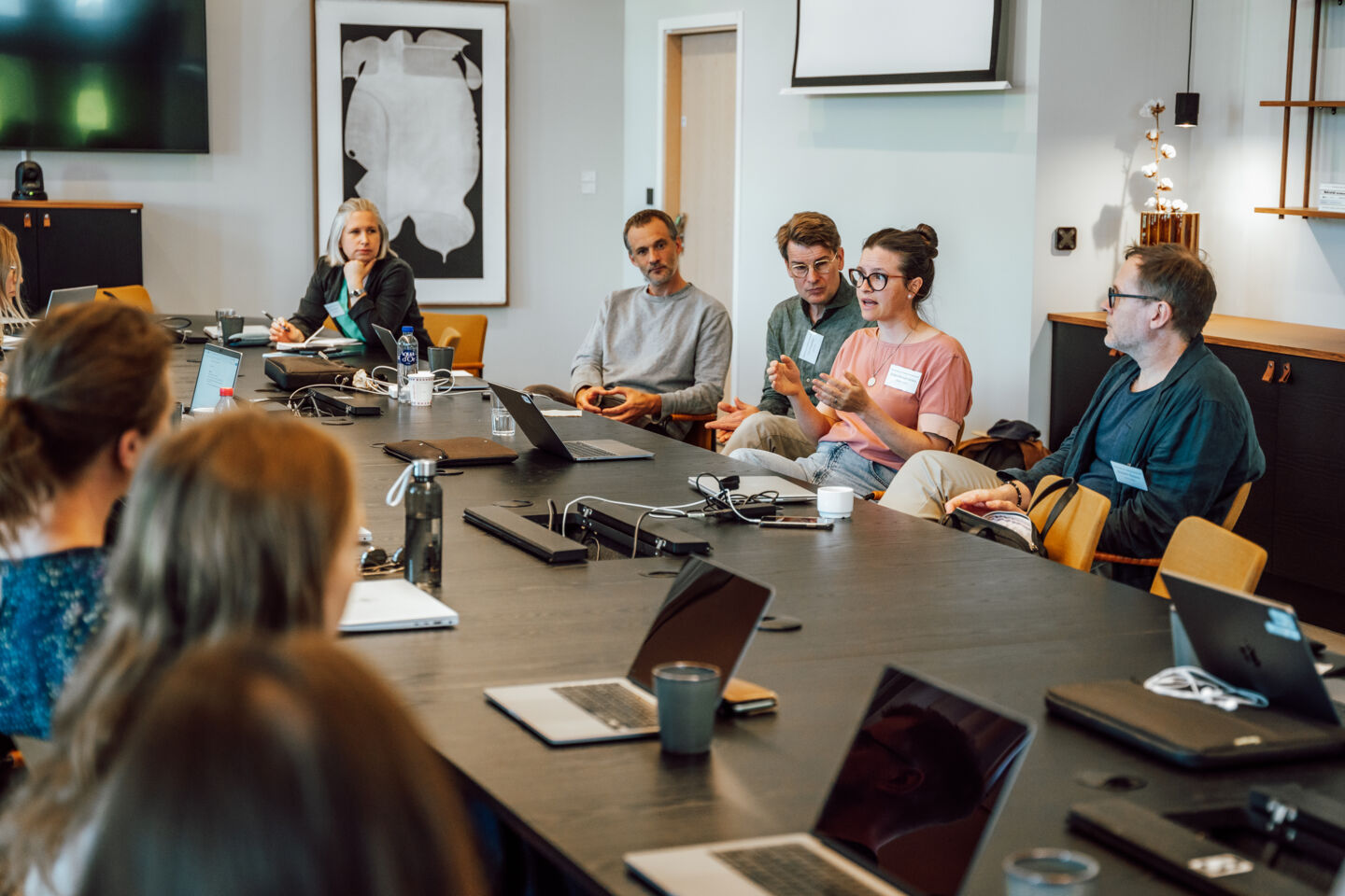 People talking by a meeting table