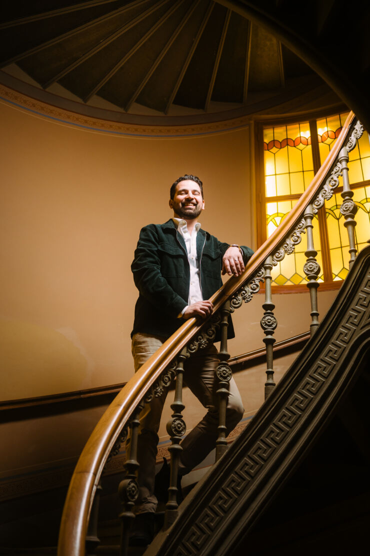 Man walking up a spiral staircase