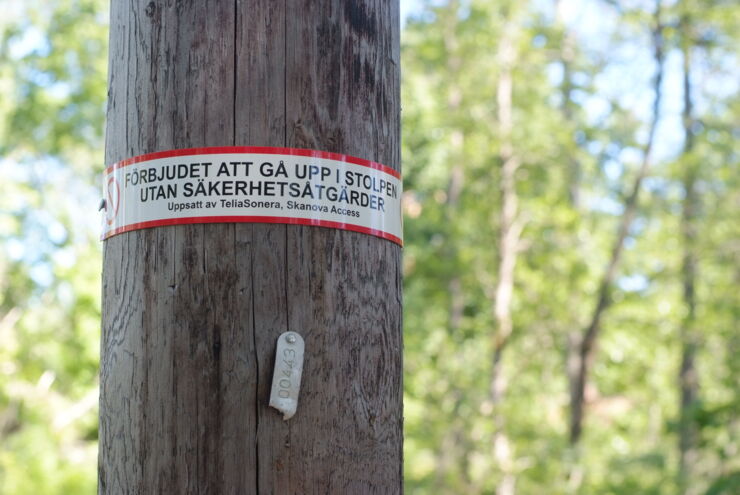 Electric pole with warning sign