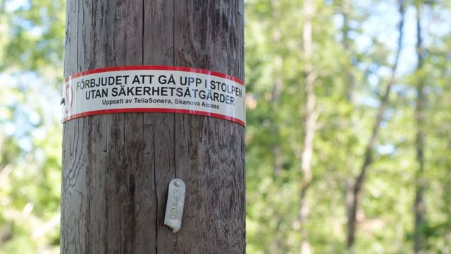 Electric pole with warning sign